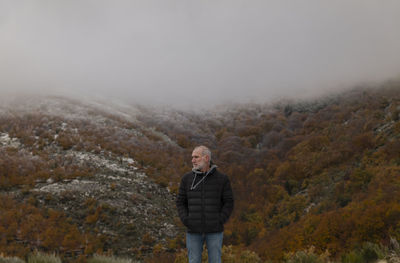 Portrait of adult man against autumn color trees on mountain, in tejera negra, guadalajara, spain