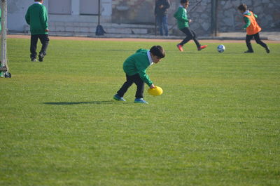 People playing soccer on field