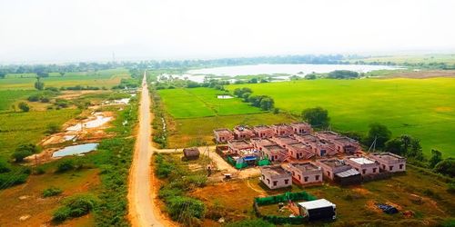High angle view of houses on field against sky
