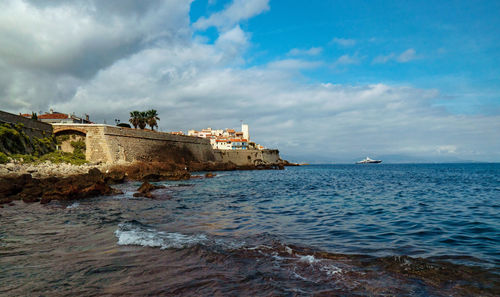 Scenic view of sea against buildings