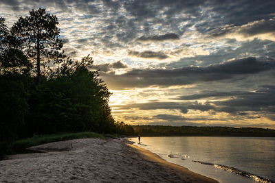 Scenic view of beach against sky during sunset