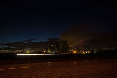 Illuminated city against sky at night