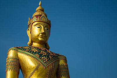 Golden image of buddha thai style on blue sky background