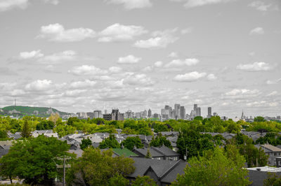 High angle view of trees and buildings against sky