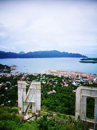 High angle view of sea and buildings against sky