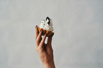 Close-up of hand holding ice cream