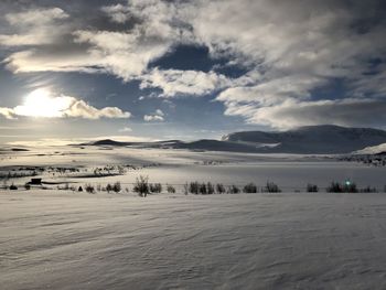 Scenic view of snow covered mountains against sky