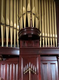 Low angle view of golden organ pipes in a temple