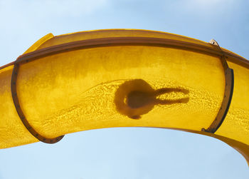 Silhouette of person sliding down water slide