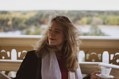 Woman looking away sitting outdoors