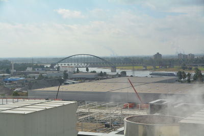 View of bridge over river against cloudy sky