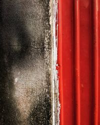 Full frame shot of window on red wall