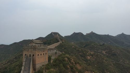 Low angle view of castle on mountain against sky