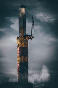 Traditional windmill against cloudy sky