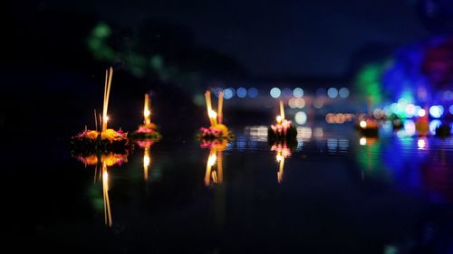 Close-up of illuminated lights on water at night