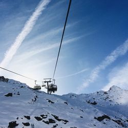 Overhead cable car against cloudy sky