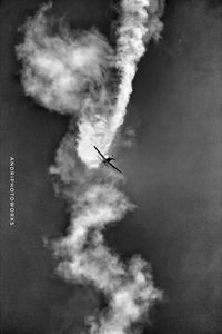 Low angle view of airplane flying against sky