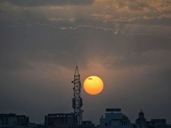 Low angle view of silhouette buildings against sky during sunset