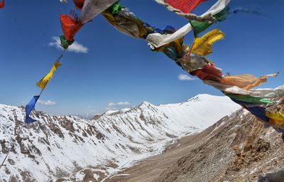 Low angle view of snowcapped mountains against sky