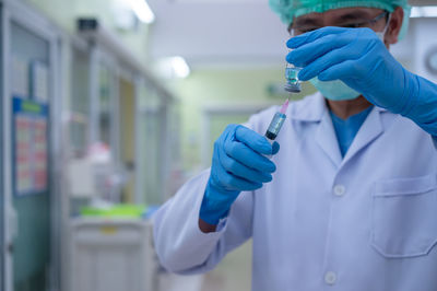 Midsection of person holding umbrella