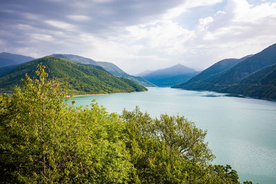 Scenic view of lake and mountains against sky