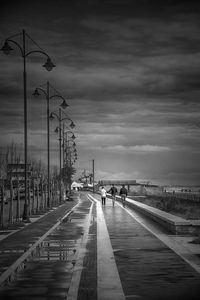 Street light against cloudy sky