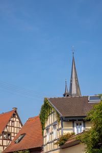 Low angle view of buildings against blue sky