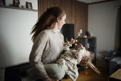 Mother playing with disabled child at home