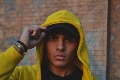 Portrait of man wearing hat against wall