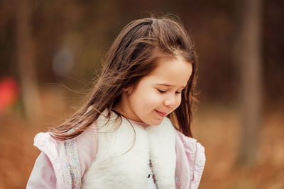 Close-up of cute girl looking down outdoors