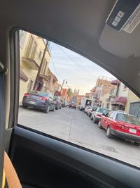 Cars in city seen through car window