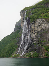 Scenic view of waterfall against sky