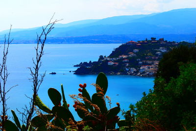 Scenic view of sea and buildings against sky