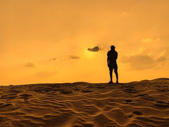 Figure staring at the desert, dubai 