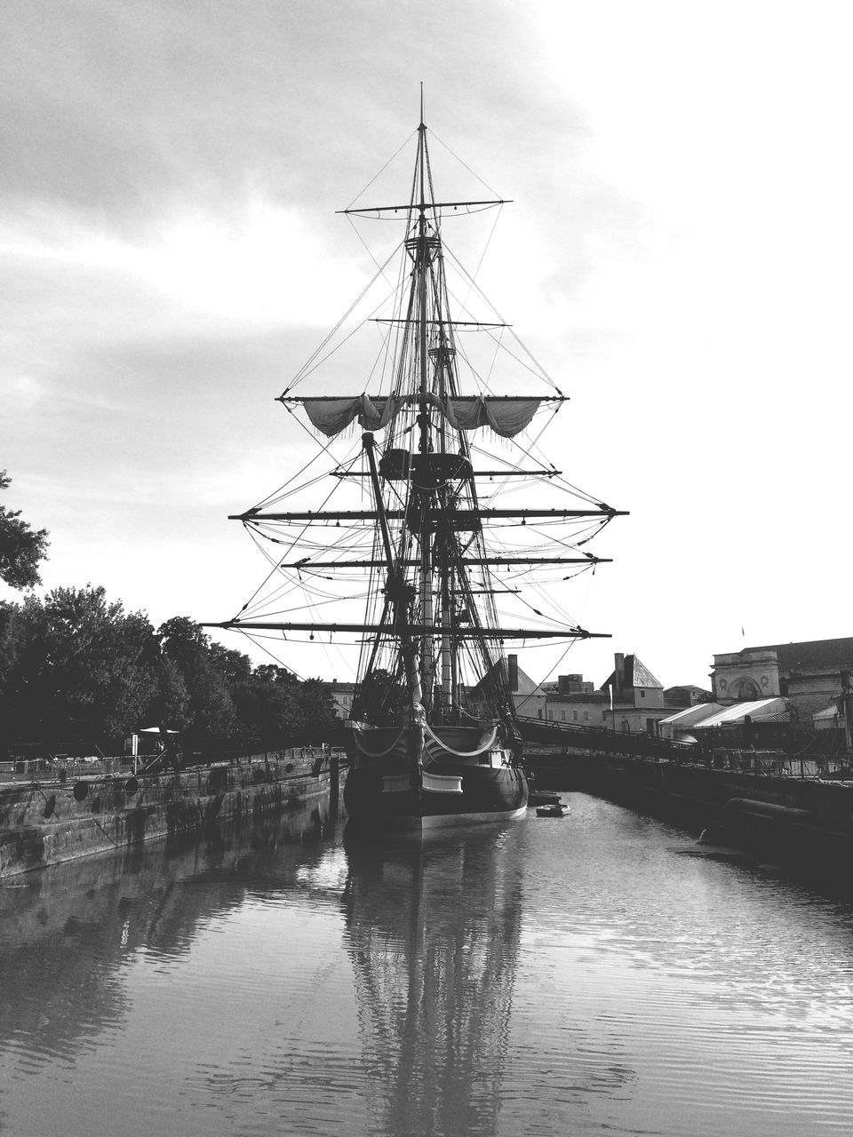 water, nautical vessel, sky, outdoors, river, day, moored, cloud - sky, mast, no people, built structure, architecture, nature, harbor, tall ship