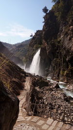 Scenic view of waterfall against sky