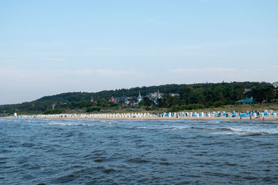 People on beach against sky