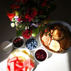 High angle view of breakfast served with flowers on table