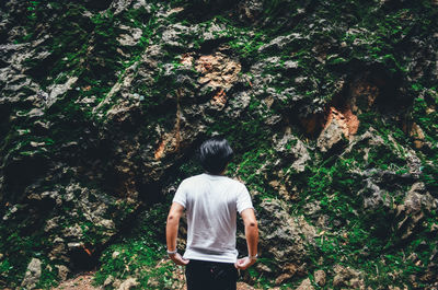 Rear view of woman walking in forest