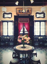 Flower vase on table in illuminated room