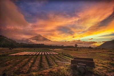 Scenic view of patchwork landscape and mountain against sky