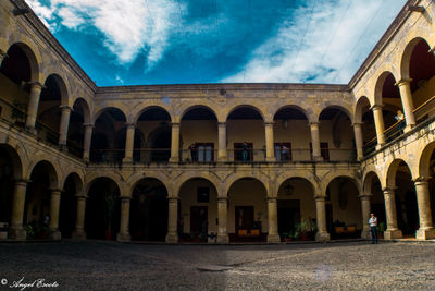 Low angle view of historical building against cloudy sky