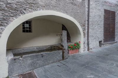 Entrance of building, fountain in a cave