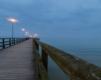 Pier over sea against sky