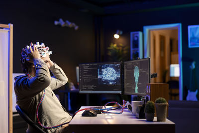 Side view of woman using mobile phone in cafe