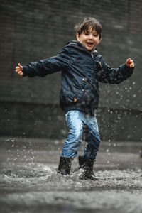 Portrait of boy standing on snow