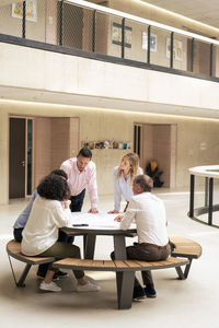 Business colleagues planning strategy in meeting at office lobby