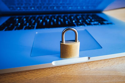 Close-up of padlock on laptop at table