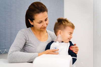 Happy mother and daughter with baby at home