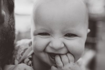 Close-up portrait of smiling cute baby girl at home